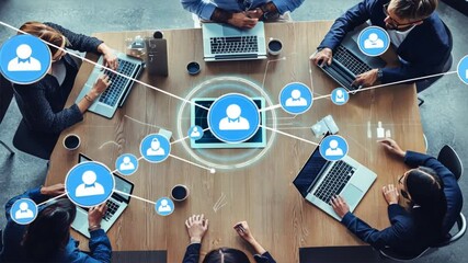 A group of people are sitting around a table with laptops - Powered by Adobe