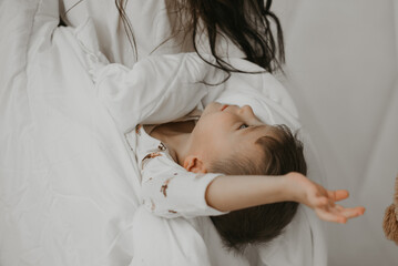 Mother tickling her laughing child