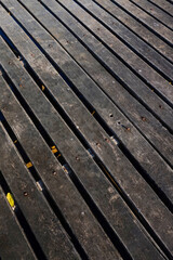 Texture of a wooden bridge that is often exposed to water and sun