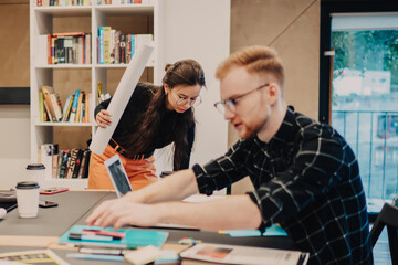 Progressive youth spending day for collaborating and learning in modern coworking space, smart...