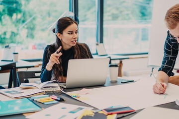 Skilled male and female graphic designers creating new architect project during collaboration on...