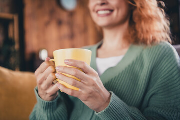 Photo of pretty cheerful lady wear green cardigan enjoying hot beverage indoors room home house