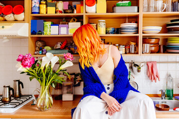 Young woman enjoying a vibrant and colorful kitchen space