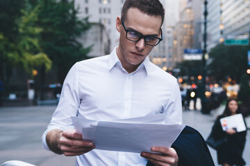 Focused trader attentively examining document