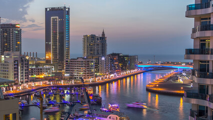 Naklejka premium An Aerial view of Dubai Marina towers in Dubai day to night timelapse