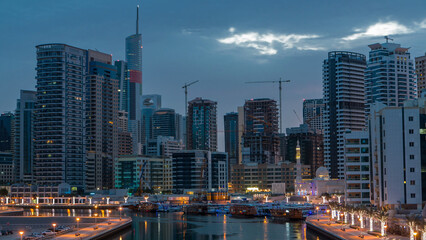 Obraz premium Dubai Marina towers and canal in Dubai night to day timelapse