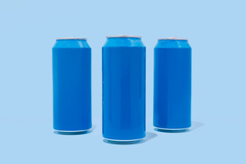 Three blue aluminum cans on blue background