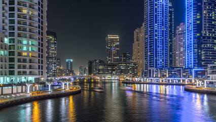 Naklejka premium Dubai Marina towers and canal in Dubai night timelapse hyperlapse