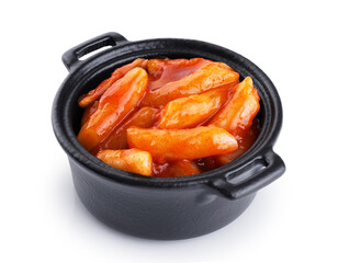 Tteokbokki rice cakes with chilli sauce isolated on white background. Korean cuisine dish.