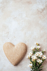 Obraz premium Heart and Flowers on a Light Beige Background