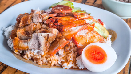 Red pork and crispy pork on rice, food in Thailand.