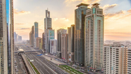 Downtown Dubai towers in the evening timelapse. Aerial view of Sheikh Zayed road with skyscrapers at sunset.