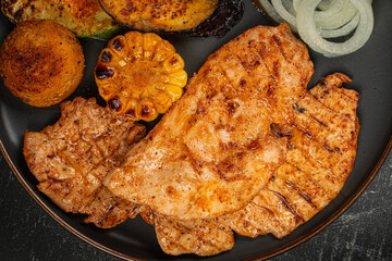 Closeup on grilled chicken breast steak with vegetables