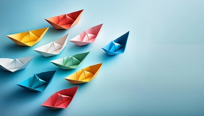 colorful paper boats floating on a light blue surface