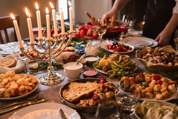 Fototapeta premium A beautifully arranged table filled with various dishes and candles for a joyful dining experience at night