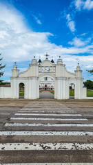 Naklejka premium Famous pilgrimage site: Basilica of the Assumption of the Virgin Mary, Aglonas Vissvetakas Jaunavas Marijas Debesis Uznemsanas bazilika, exterior view of the church with garden in summer in Aglona, ​​