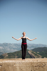 Freedom in nature, gymnastics on a sunny day, yoga against the sky. Body exercises