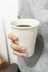 Coffee cup in hand front view