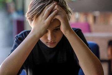 Sad child, stress and depression. Fear children hand cover face. Boy covering face with hands....