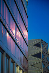 Contemporary residential building exterior in the daylight. Modern apartment buildings on a sunny day with a blue sky.