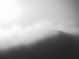 Fototapeta premium Photo Misty Mountain Peak through Clouds