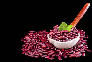 beans in a black plate close-up on a gray background. vitamin b. banner for insertion on the site