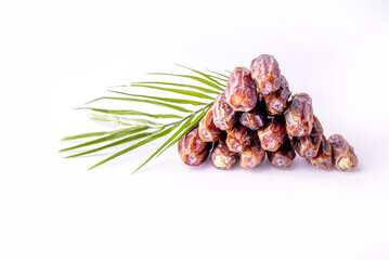 Dried date and green mint in a bowl on white table close up