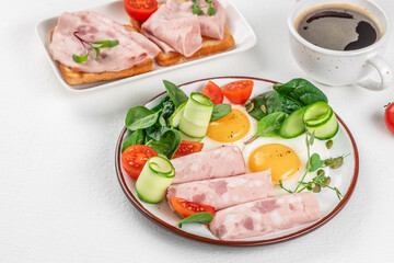 Plate of breakfast with fried eggs, ham and salad. Keto breakfast. Brunch