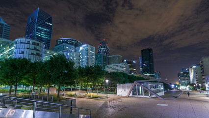 Paris cityscape with modern buildings in business district La Defense timelapse hyperlapse by night. Paris, France