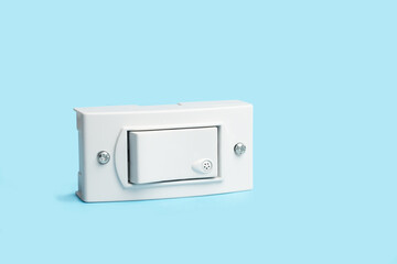 Light switch on a light blue background with copy space