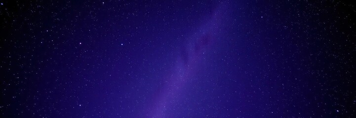 Naklejka premium Deep purple and blue night sky with countless tiny stars creating a cosmic glow, starry night, cosmos
