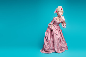 Full length photo of young woman empty space wear renaissance queen costume isolated on teal color...