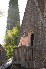 A man in a Venetian mask on Juliet's balcony in Gagra