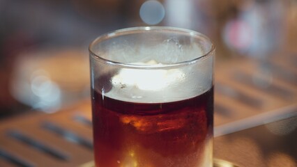 Focusing serving mist smoky classical in Old fashioned of whiskey cocktail presentation on bokeh background recommending special welcome tasty creative advertisement drink at beverage bar. Vinosity.