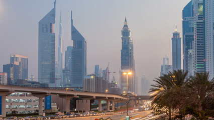 Fototapeta premium Traffic on intersection and bridge at the Sheikh Zayed Road day to night timelapse