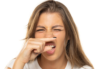 Fototapeta premium portrait of a young woman smelling a bad smell