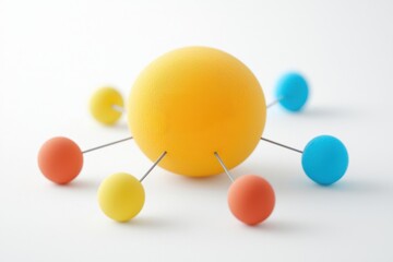 Obraz premium A colorful model representing an atom, showcasing a central sphere surrounded by smaller spheres connected by thin rods, ideal for educational use.