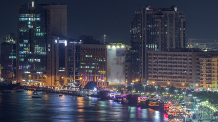 Fototapeta premium Dubai creek landscape night timelapse with boats and ship near waterfront