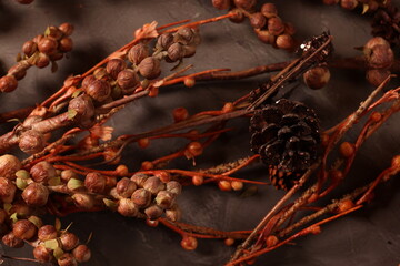 Cozy autumn decor with candles, pinecones, and berries, creating a rustic, seasonal ambiance perfect for fall.