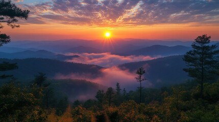 Obraz premium A breathtaking panoramic view of a mountainous landscape at sunrise, with rays of sunlight breaking through the clouds, highlighting the misty valleys below