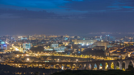 Panoramic view over Lisbon and Almada from a viewpoint in Monsanto night to day timelapse.