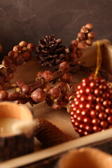 Cozy autumn decor with candles, pinecones, and berries, creating a rustic, seasonal ambiance perfect for fall.