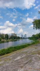 Tranquil riverside view with a mix of natural and urban elements