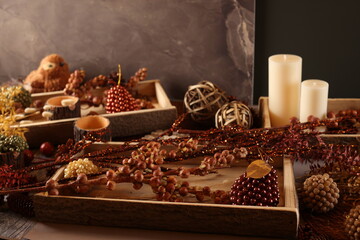 Cozy autumn decor with candles, pinecones, and berries, creating a rustic, seasonal ambiance perfect for fall.