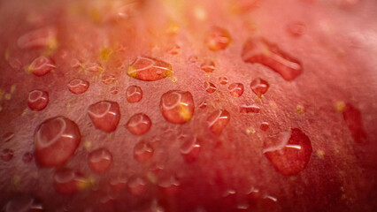 Texture-rich macro photo of a red apple, capturing water droplets on its skin for a fresh and vibrant look.