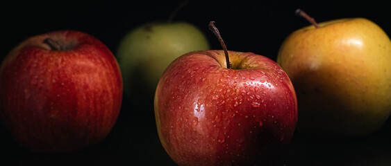 Still life of apples with dewdrops, representing healthy eating and organic produce.