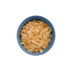 bowl of dried coconut chips flakes raw