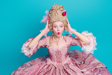 Photo of shocked charming lady british queen wear pompous pink ruches gown corset sit floor isolated on blue color background