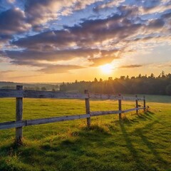 Obraz premium A high-resolution ultrarealistic image captures a serene countryside at sunrise. The digital photo depicts a sun rising behind a line of tall pine trees, casting golden sunlight across a dew-covered g