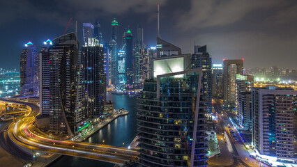 Aerial view of Dubai Marina residential and office skyscrapers with waterfront night timelapse hyperlapse